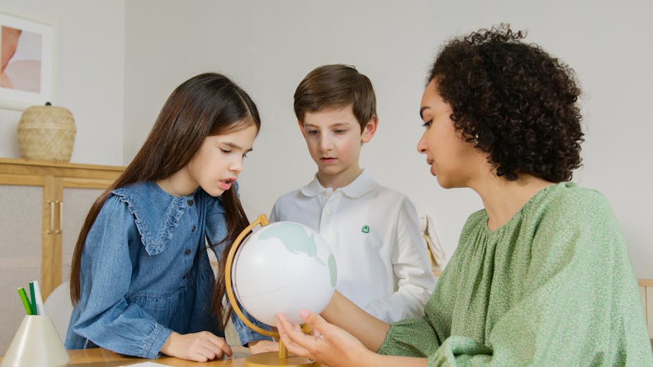 A teacher and two children exploring a globe.