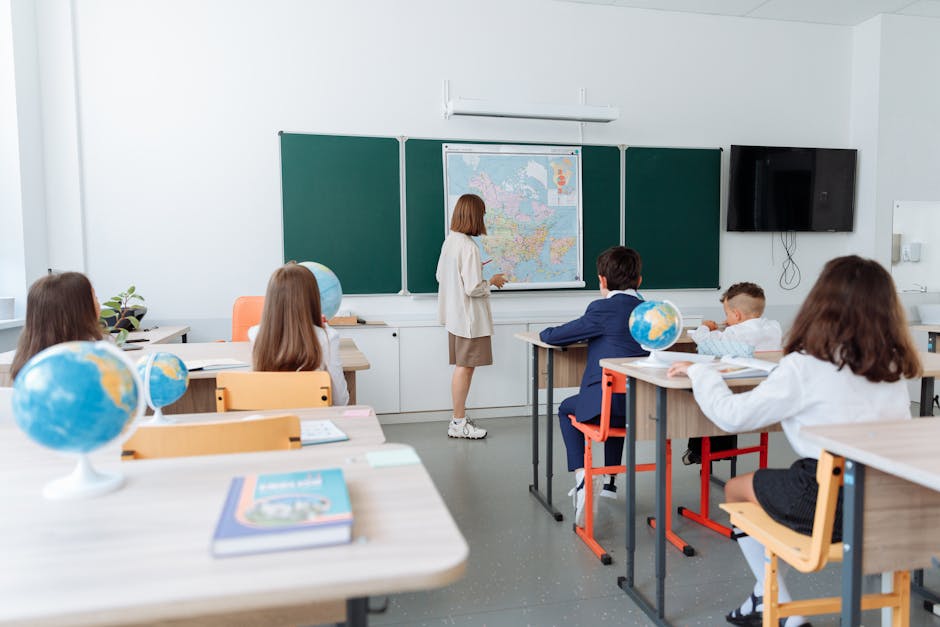 Students engaged in a geography lesson, focusing on a wall map in a classroom.